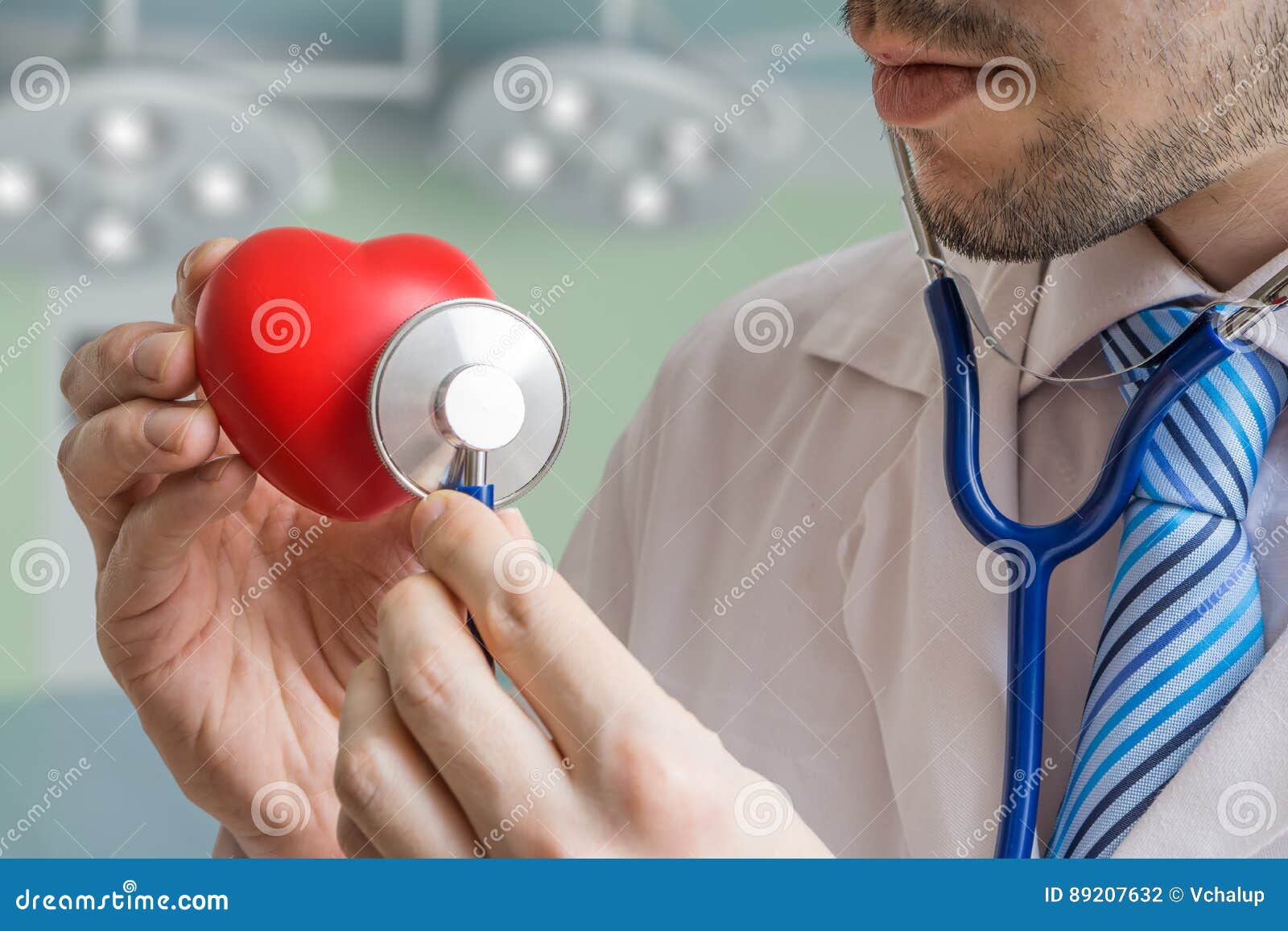 cardiologist doctor is listening red heart with stethoscope