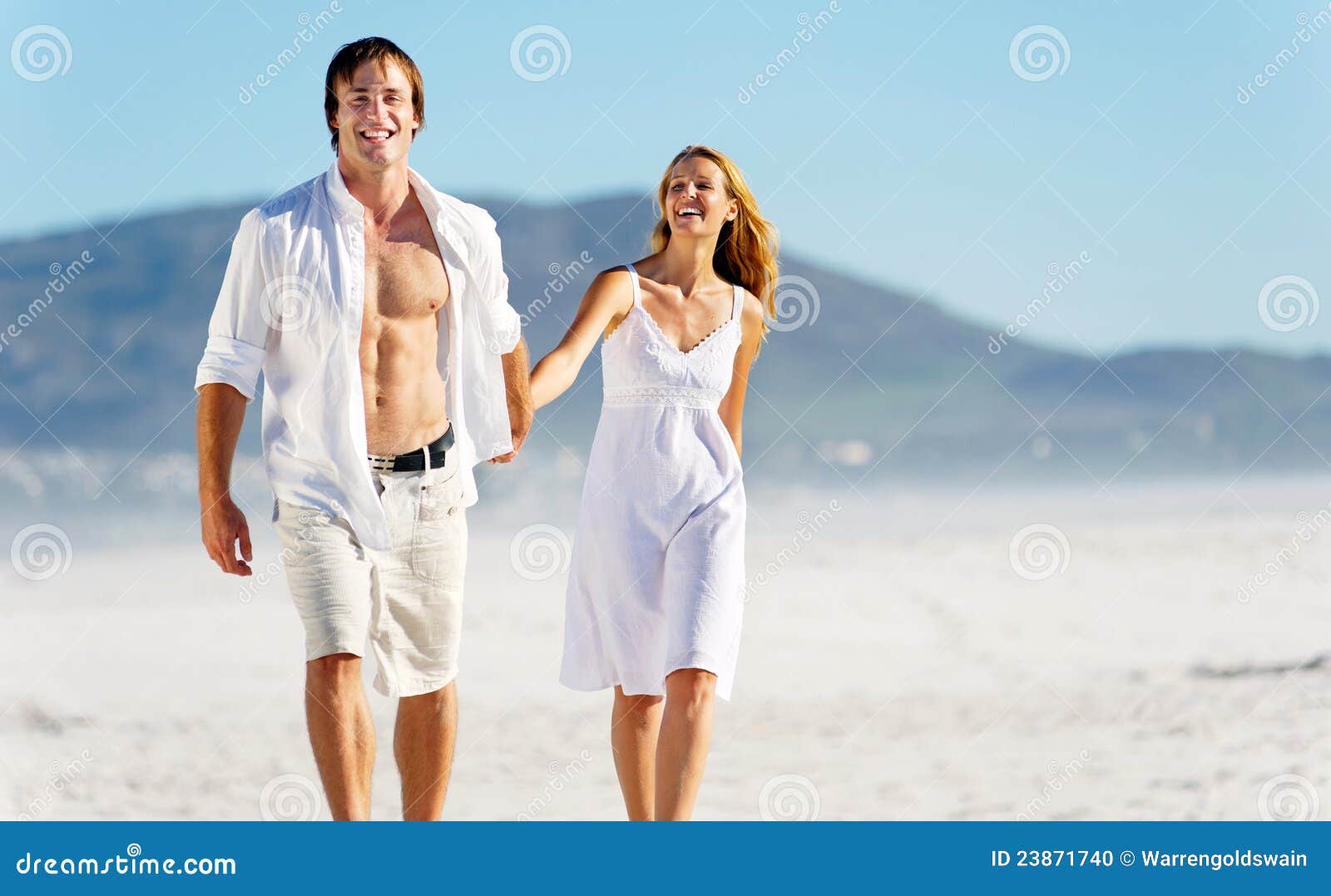 carefree walking beach couple