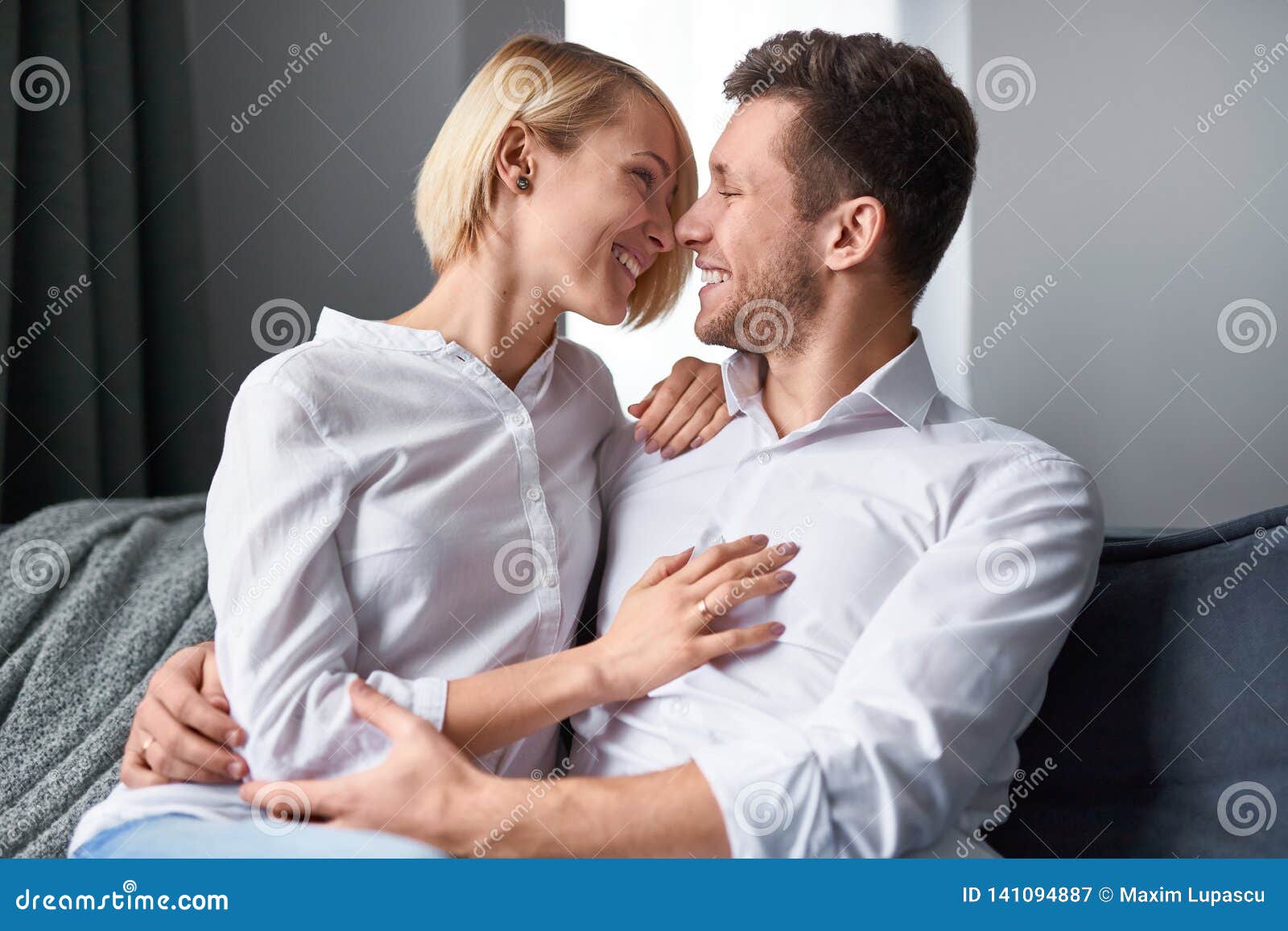 Caressing Couple In Love Sitting On Couch Stock Image Image Of Sensual Relationship 141094887