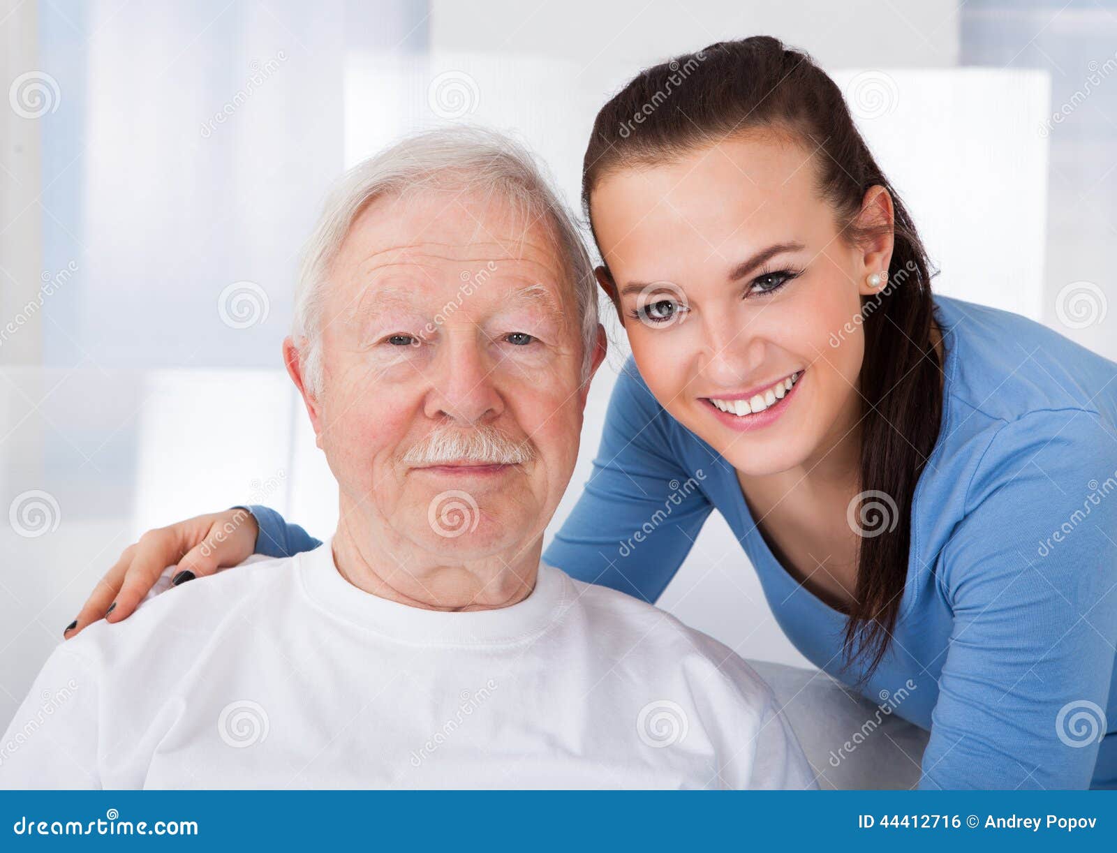caretaker with senior man at nursing home