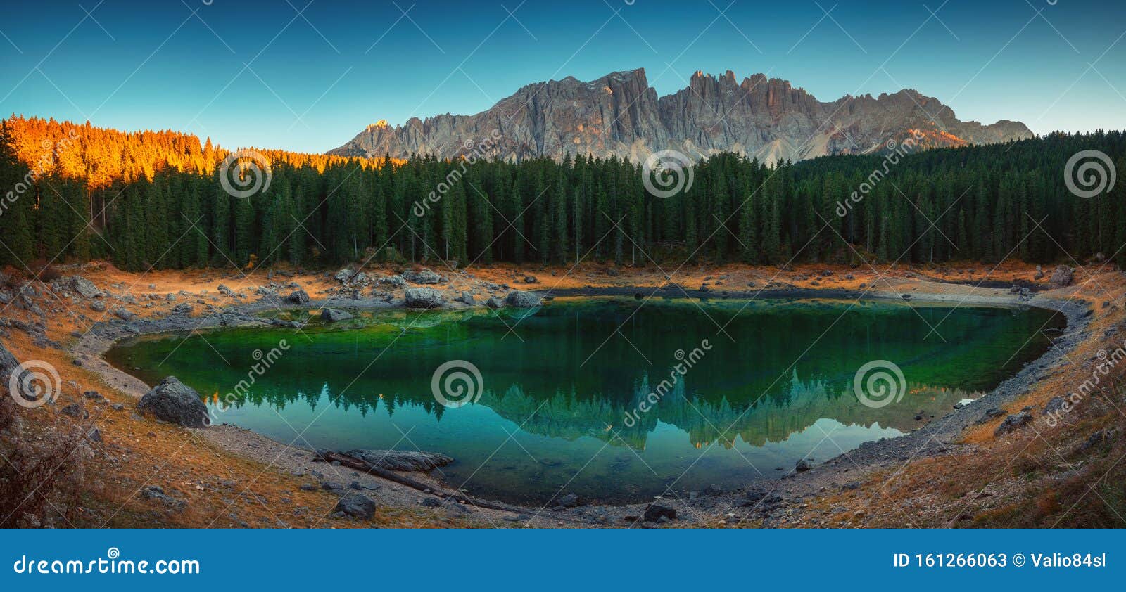 carezza lake in dolomitesn  or lago di carezza with reflection of mountains at sunset in the dolomites, south tyrol, italy