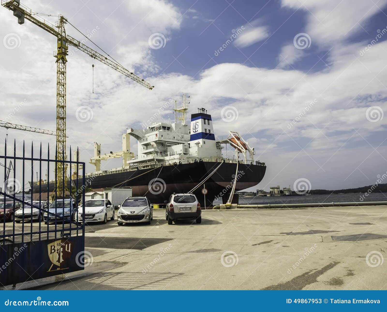 Cargo ship in port. Pula editorial stock photo. Image of angle 49867953