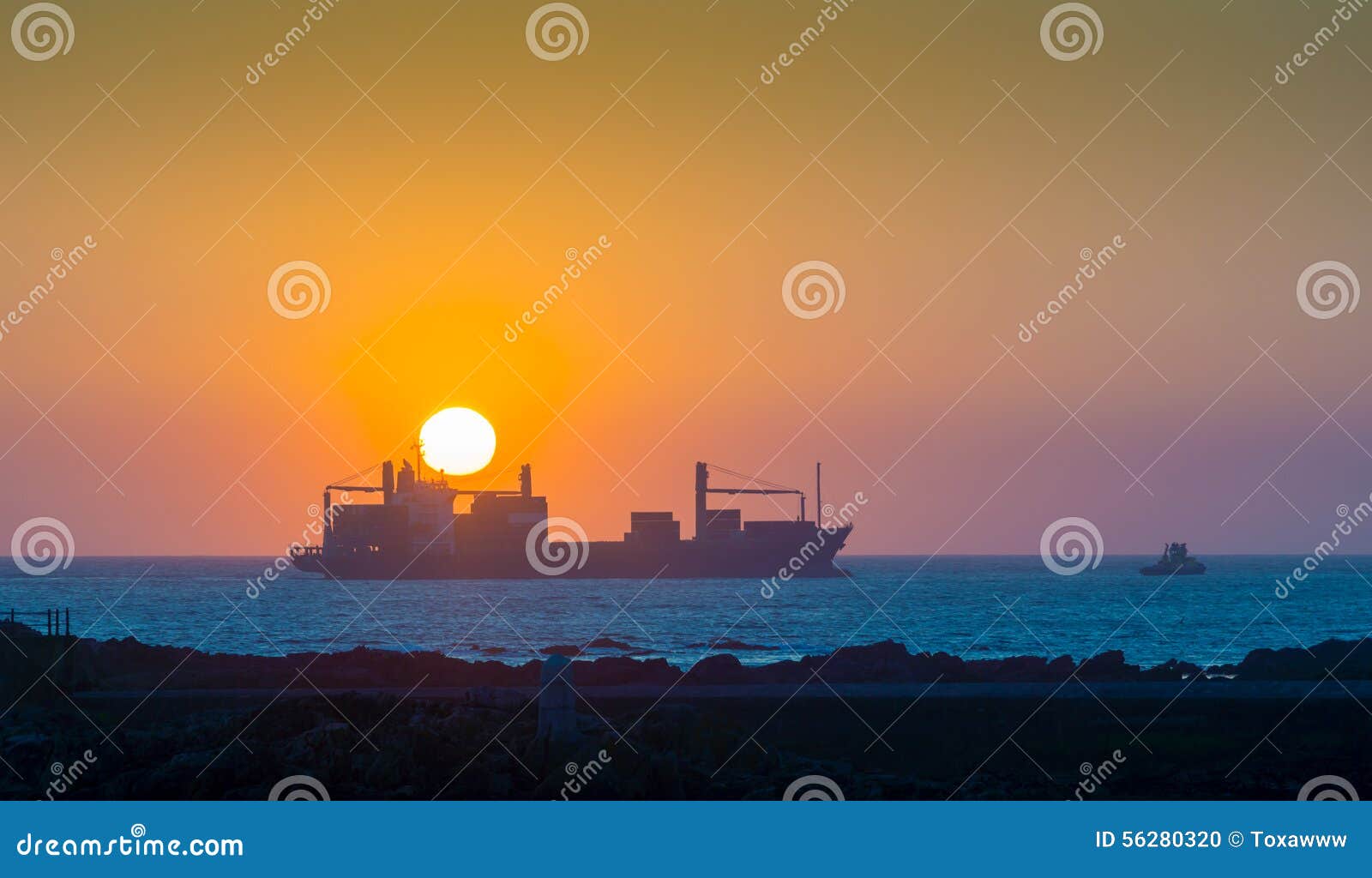 Cargo ship at sunset in the Atlantic Ocean