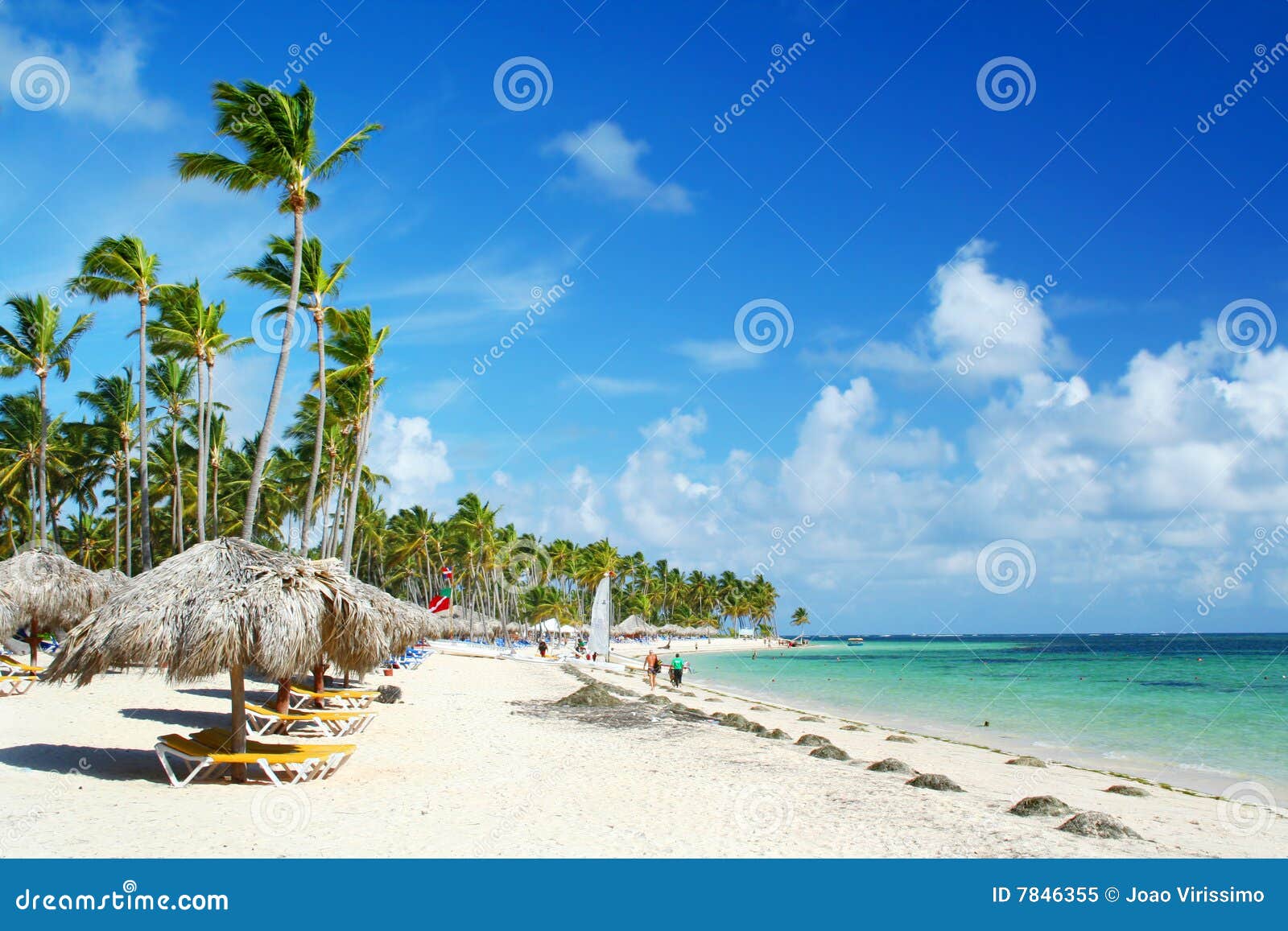 caribbean resort beach with umbrellas and chairs