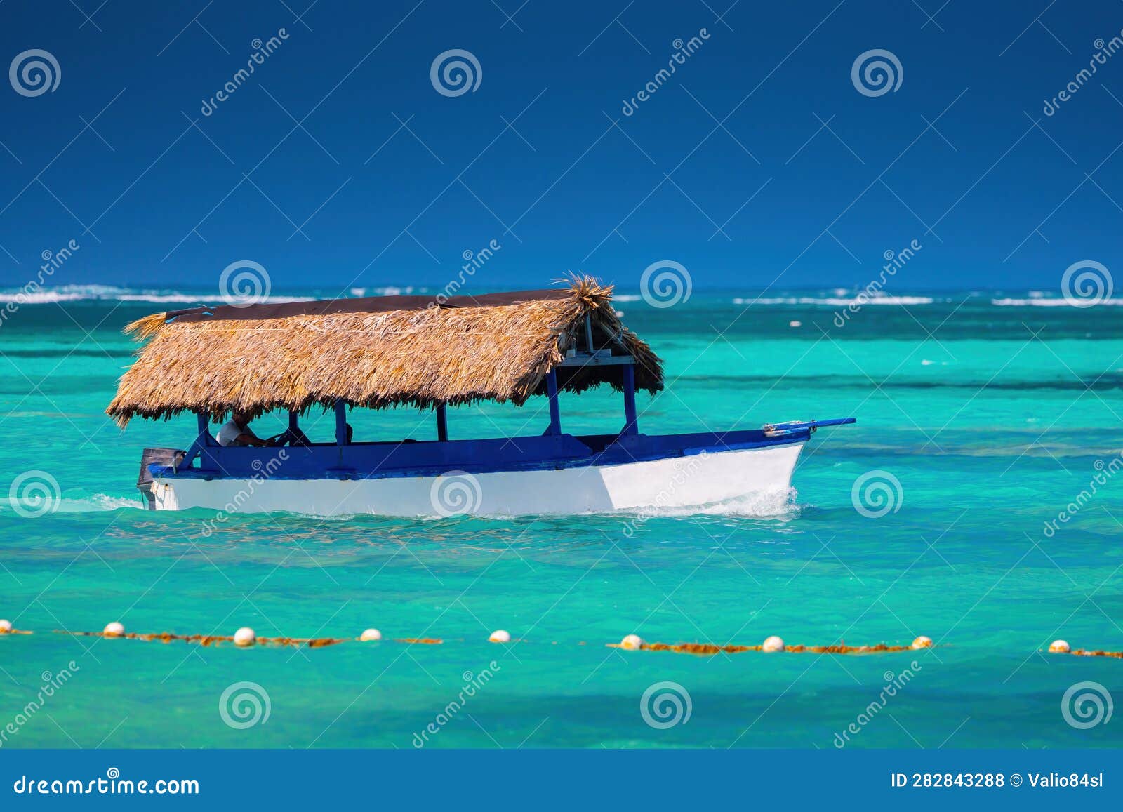 caribbean sea and sailing boat on the water, hot summer day on the caribe. punta cana, dominican republic