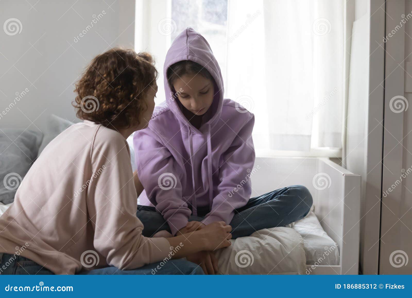 caring mom talk with sad teenage daughter suffering at home