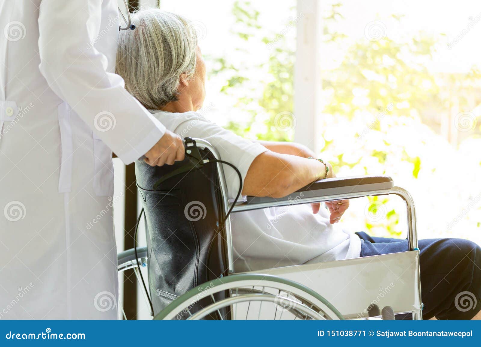 caring doctor or nurse supporting disabled,alzheimer senior asian woman on wheelchair,female caregiver walking,elderly patient