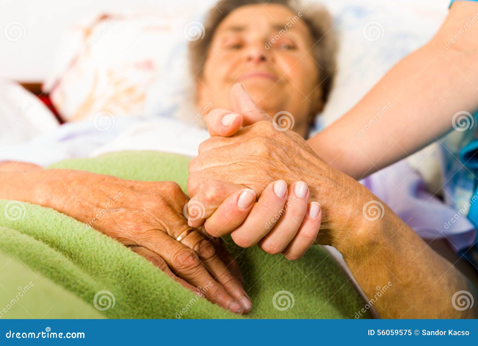 caring nurse holding hands