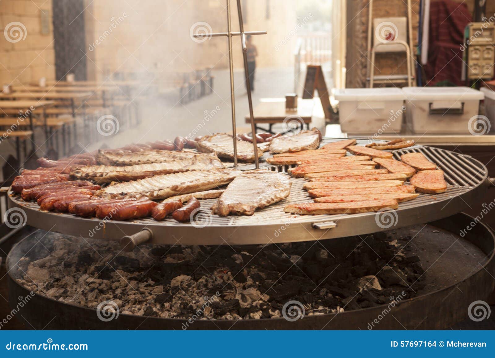 A carne gourmet remenda os reforços de carne de porco, salsichas, em uma grande grade na Espanha