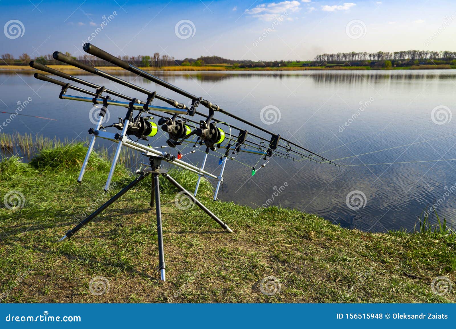 Carp Fishing Rods Standing on Rod Pod Near the Lake during Sunrise