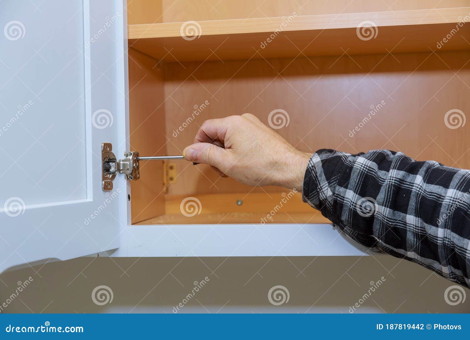 Carpenter Adjusting a Metal Hinges for Doors Stock Photo