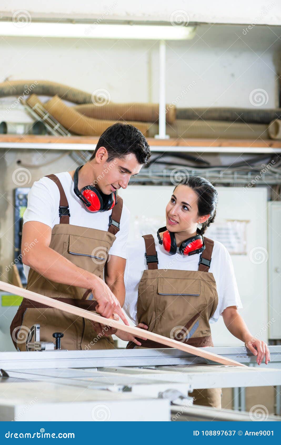 Carpenter and Apprentice Working Together in Stock Image