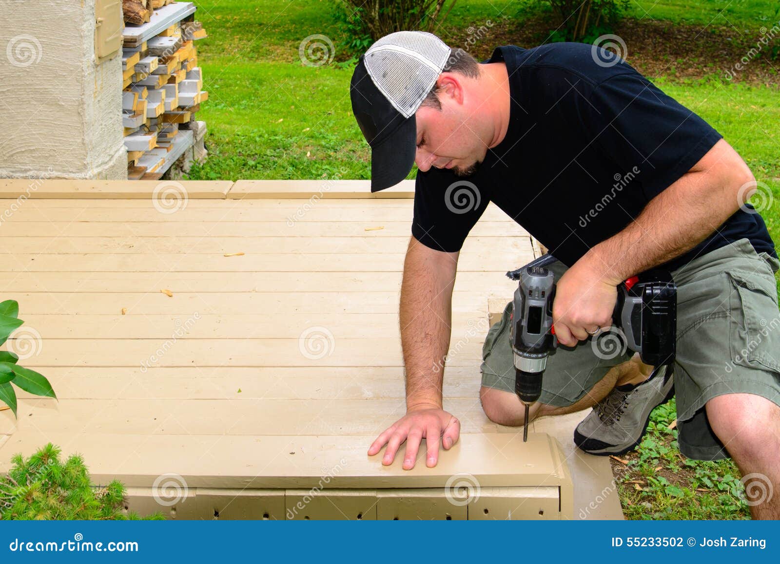 carpenter bulding deck with drill