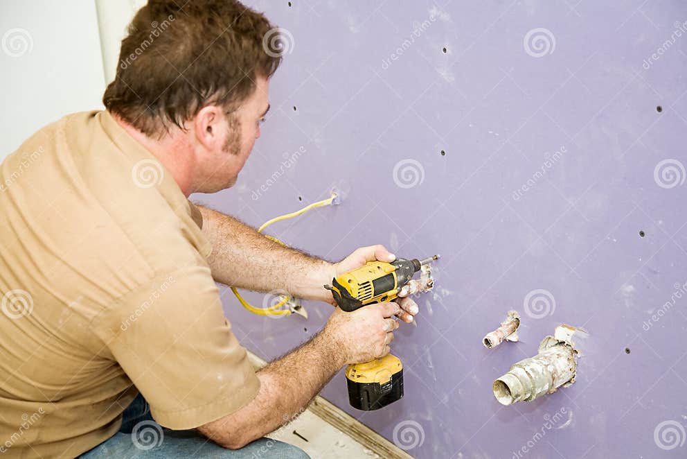 Carpenter Installs Drywall stock image. Image of purple 6883535