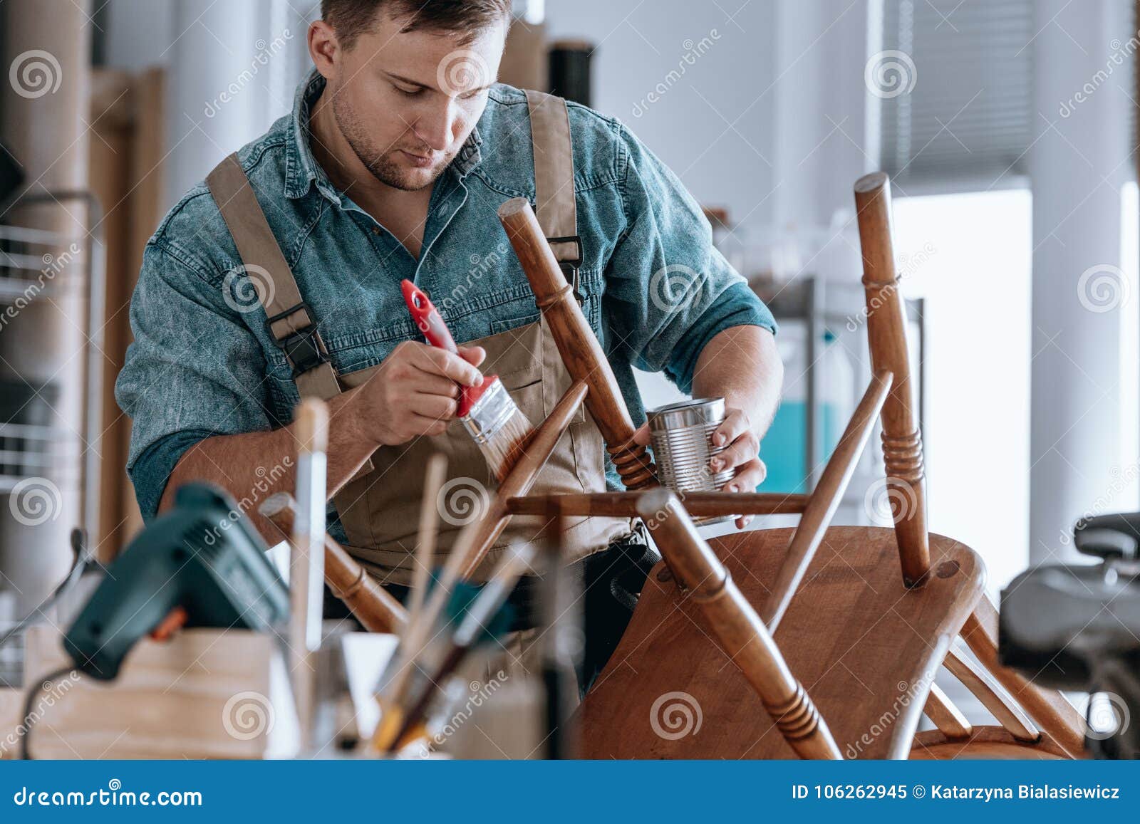 carpenter painting wooden chair