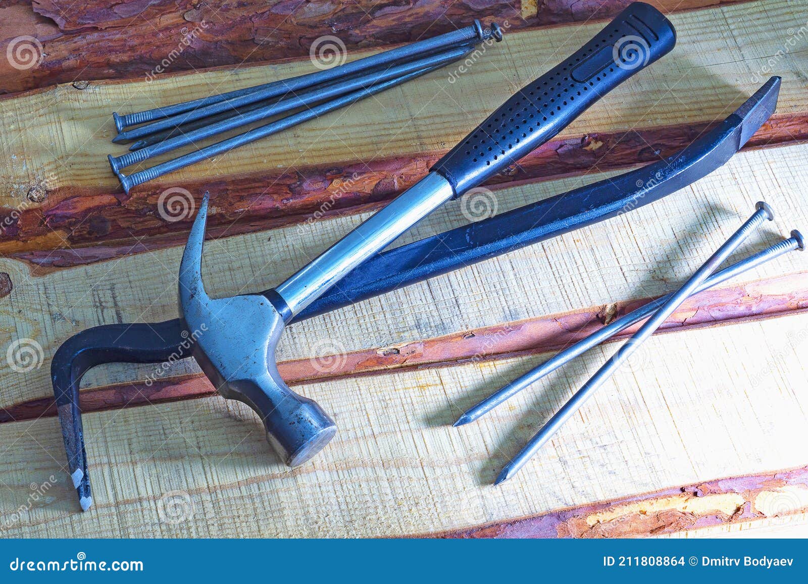 Carpenter`s Crowbar and Hammer Lying on the Wooden Floor Stock Photo