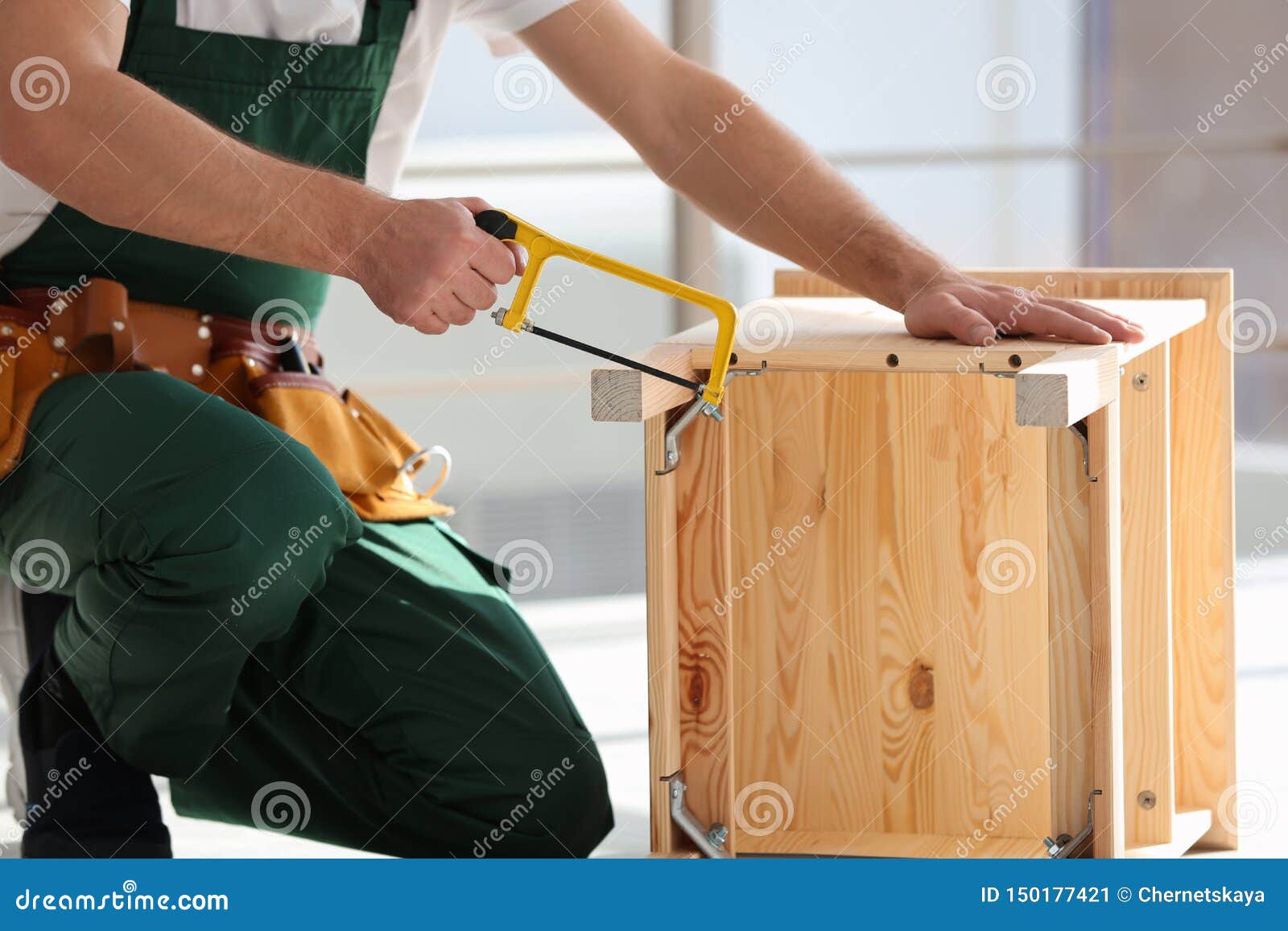 Carpenter In Uniform Making Furniture Indoors ...