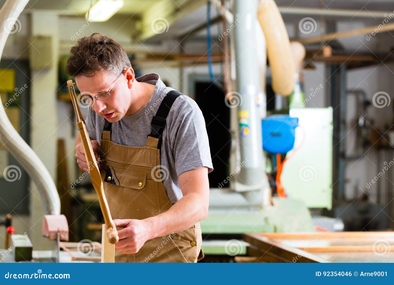 Carpenter using hand saw stock photo. Image of working 92354046