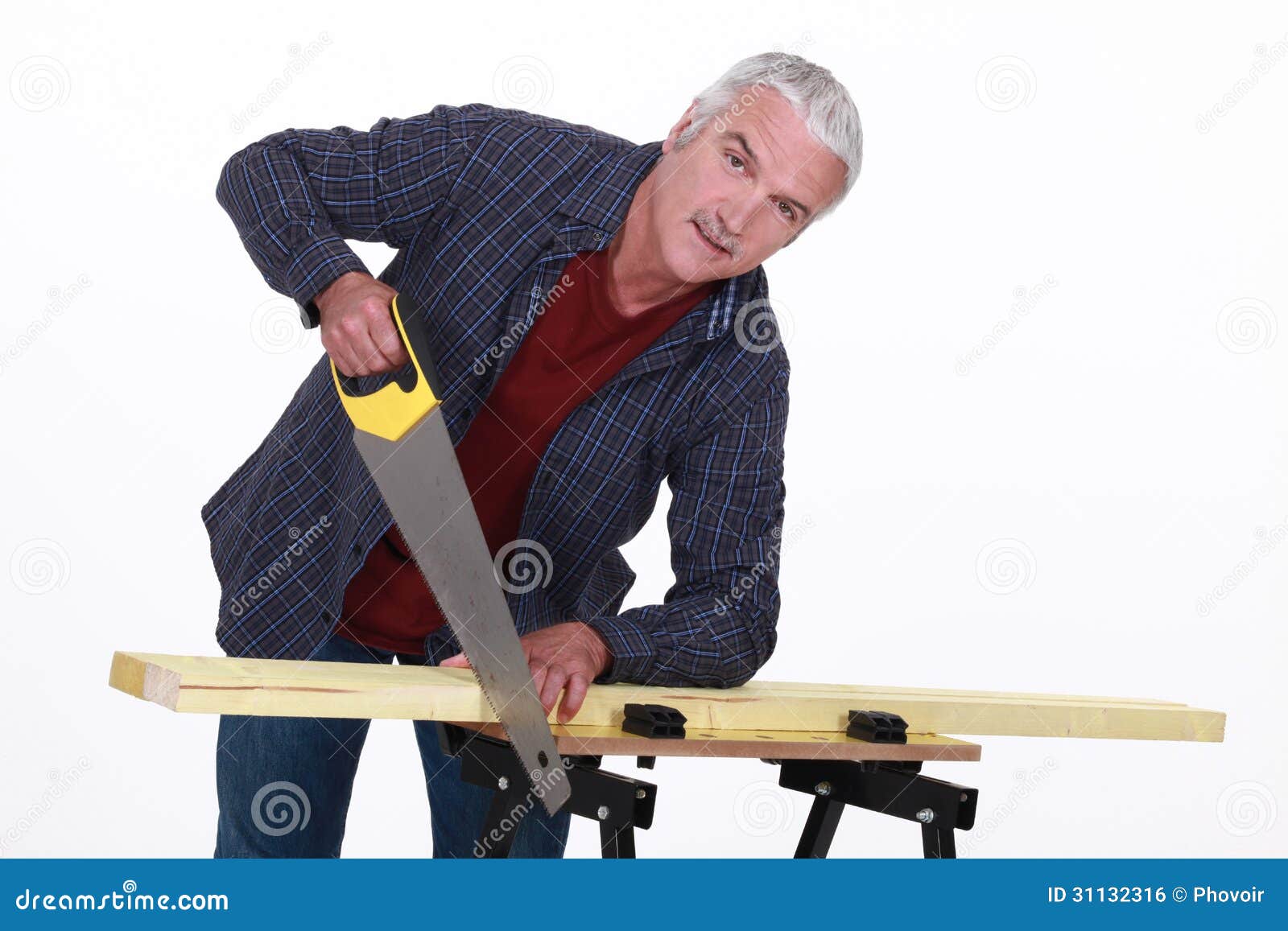 Carpenter using a handsaw stock photo. Image of home 31132316
