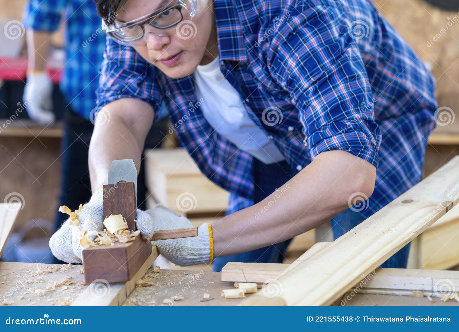 A Carpenter is Using a Wood Sharpener. Carpenter Using Back Planer