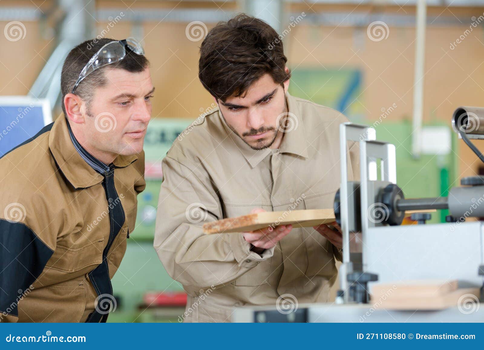 African American Male Carpenter Sitting at Table Showing Model Car