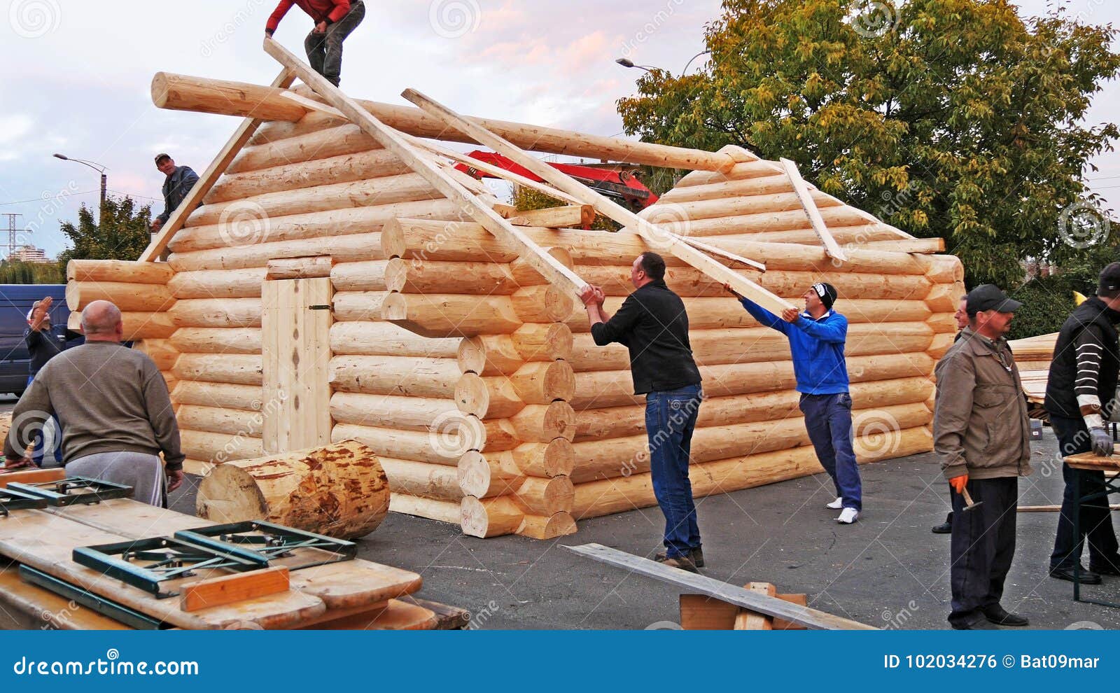 Carpenters Lifting Square Timber Rafters To The Roof Editorial