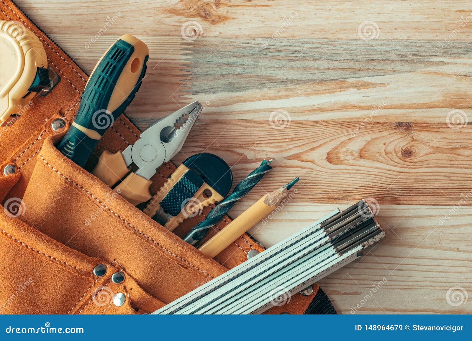 carpentry tool belt on woodwork workshop desk, top view