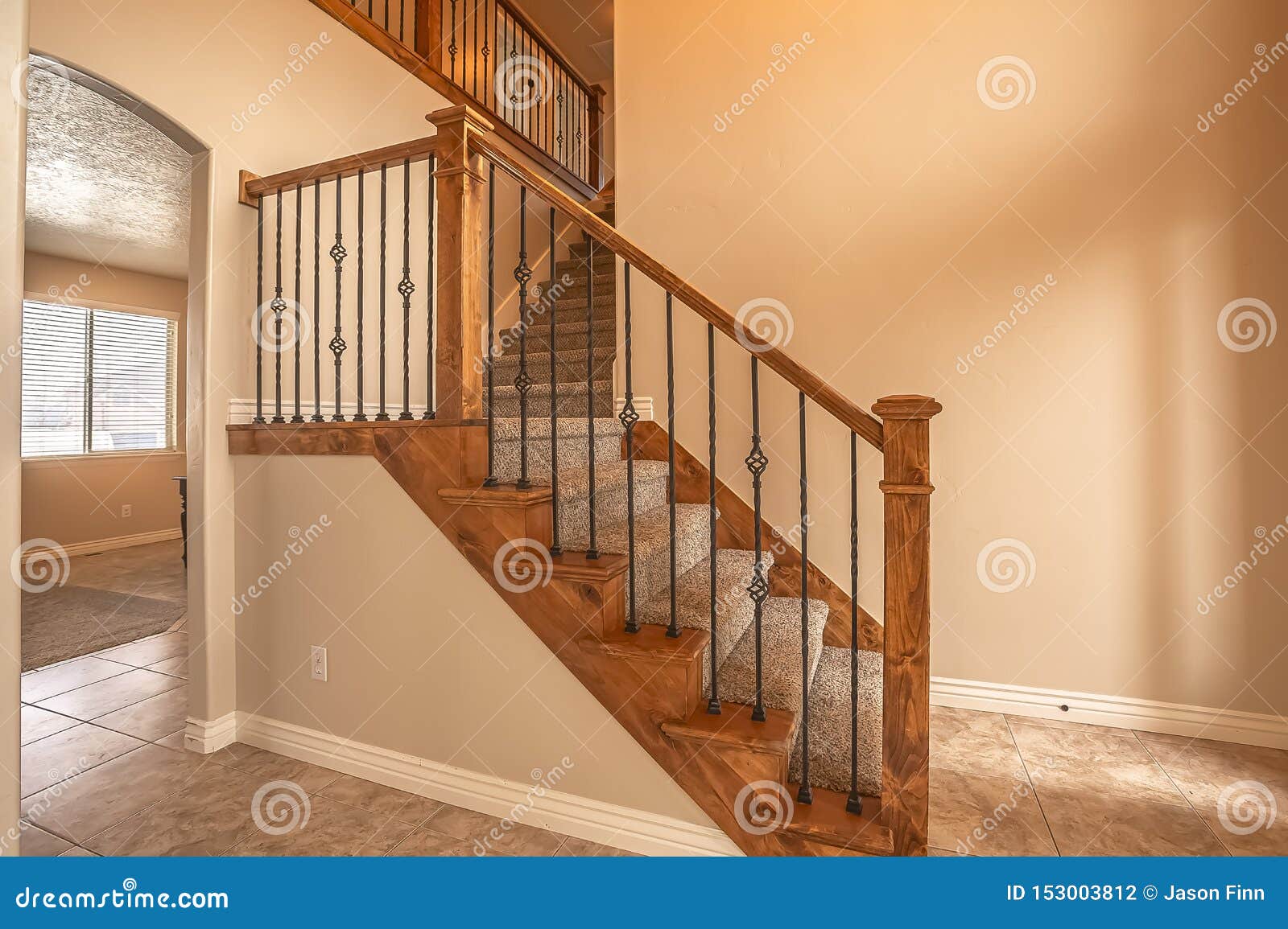 Carpeted Stairs With Wood Handrail And Metal Railing Inside