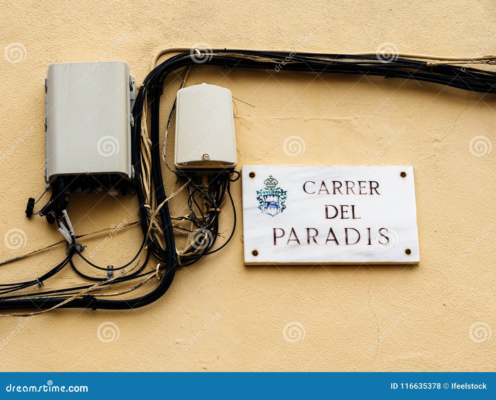 carrer del paradis street name plaque with optic fiber hub