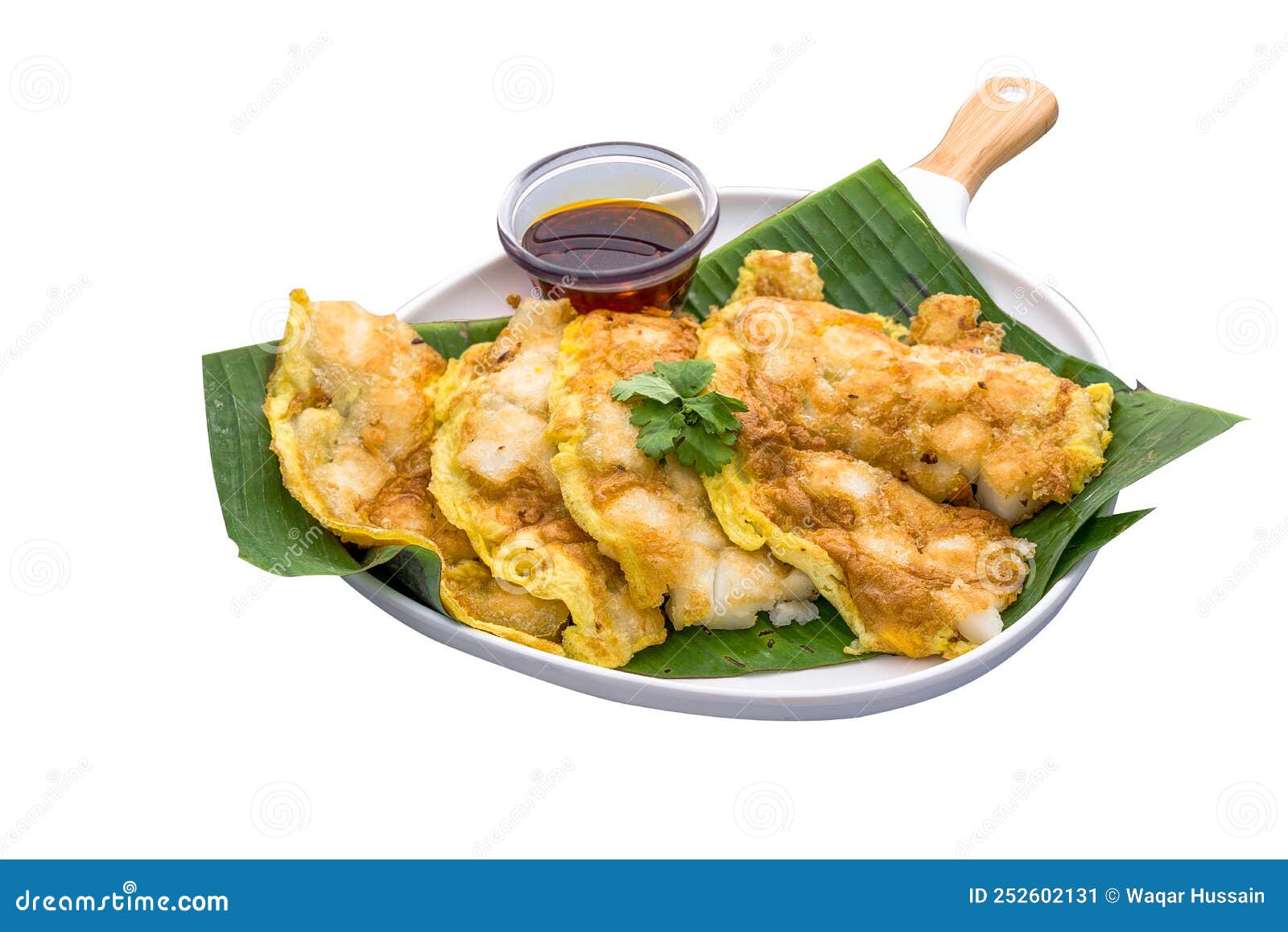 carrot cake with mala chilli dipping sauce served in a dish  on plain white background side view of orh luak carrot cake