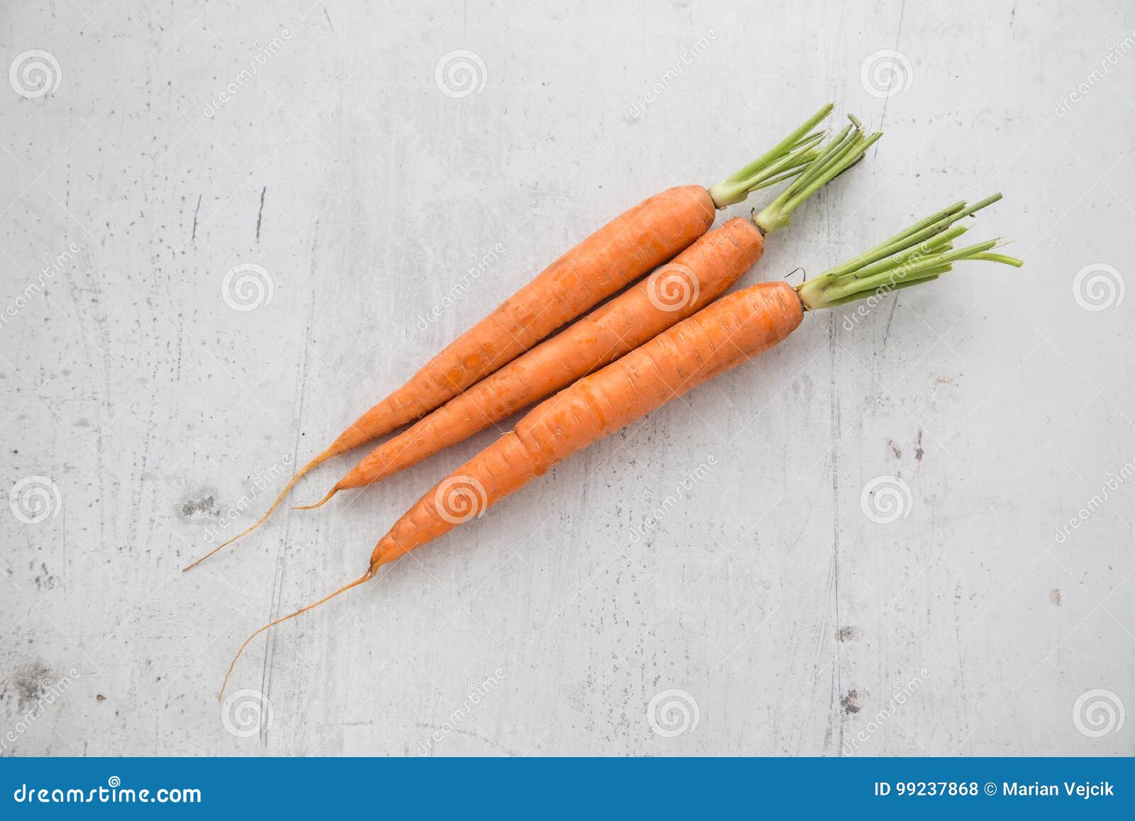 carrot. fresh carrot on white concrete board