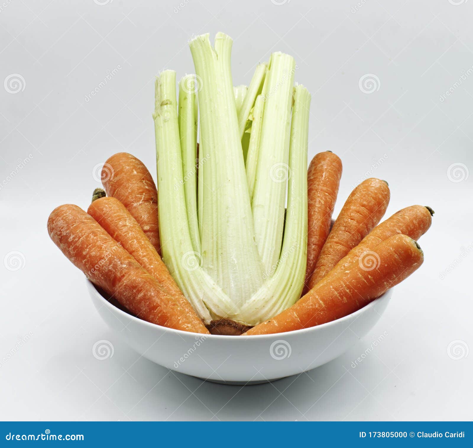 Carrots and Celery in a White Bowl, Isolated on White. Stock Photo