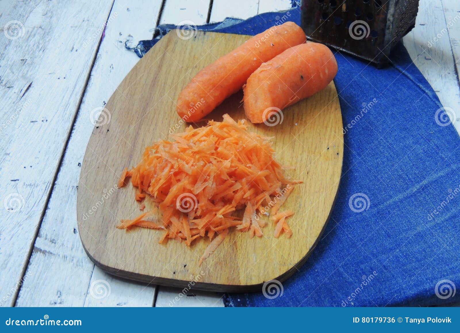 Carrots grated on a grater stock photo. Image of background 80179736