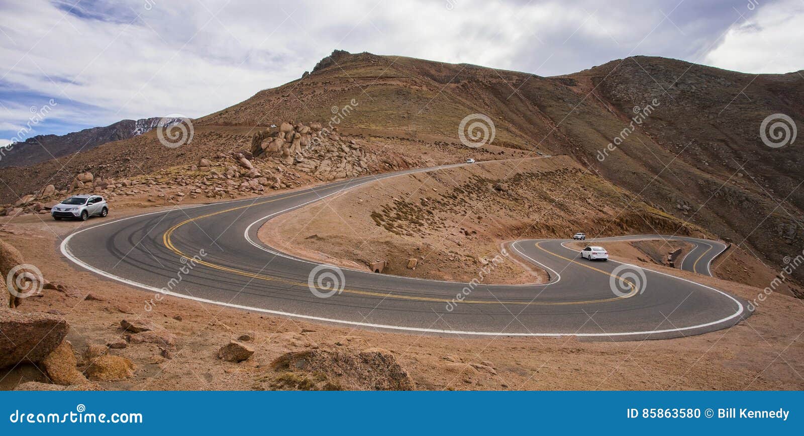 cars on the steep, winding road up pikes peak, colorado