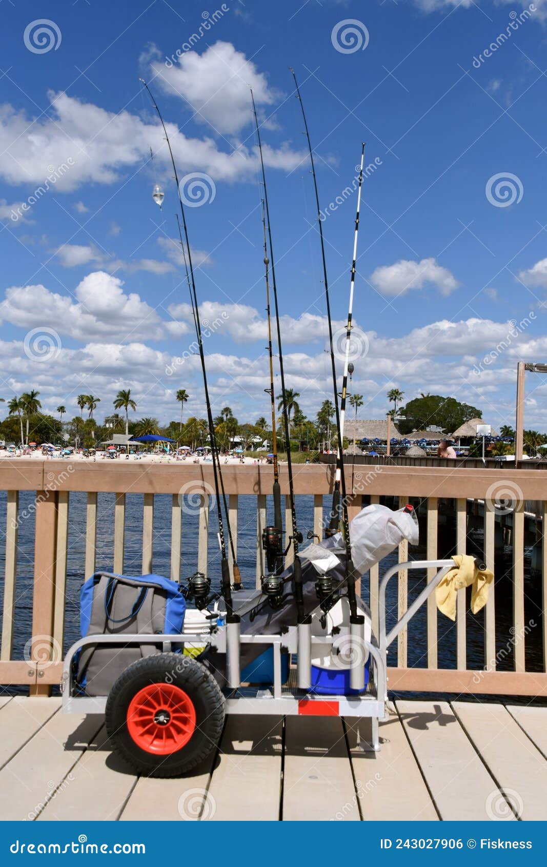 A Cart Full of Fishing Gear is Located on a Pier with a Beach in the  Background Stock Photo - Image of sportsman, gear: 243027906