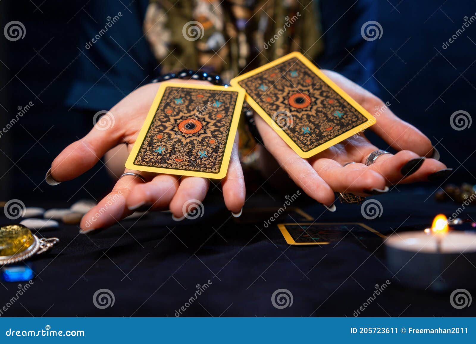 cartomancy. the fortune teller holds out two tarot cards on her palms. close up. the concept of divination, astrology and