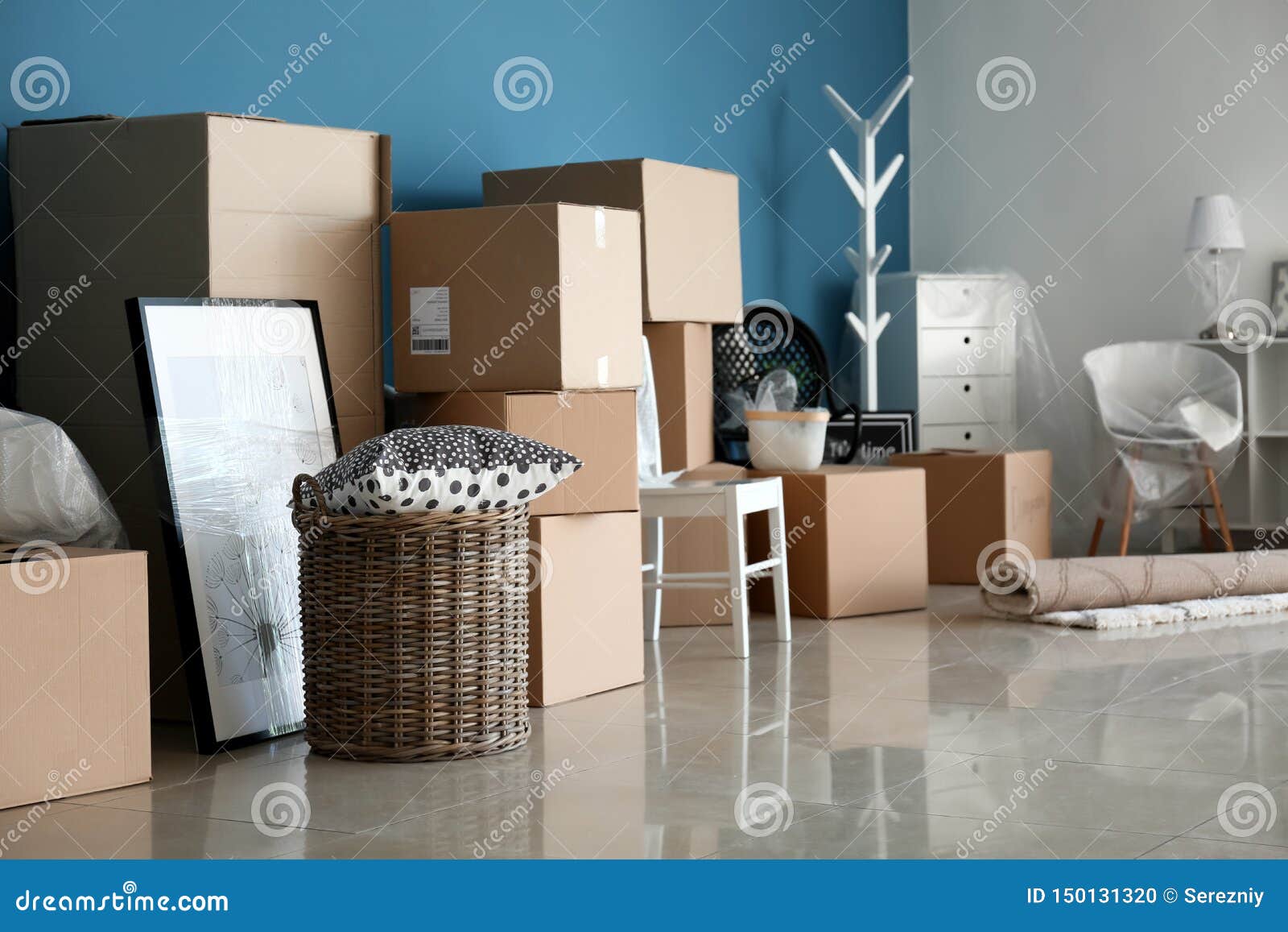 Carton boxes and interior items on floor in room. Moving house concept