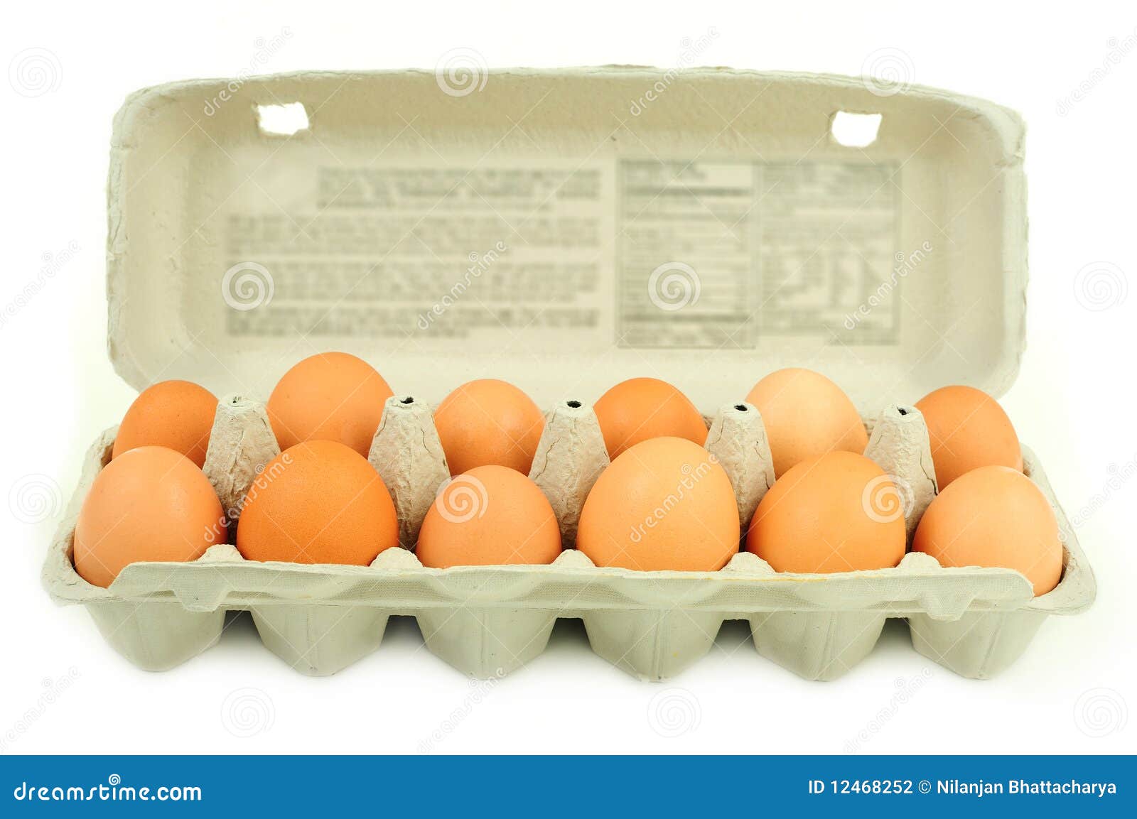 Carton of dozen brown eggs stock photo. Image of food 12468252