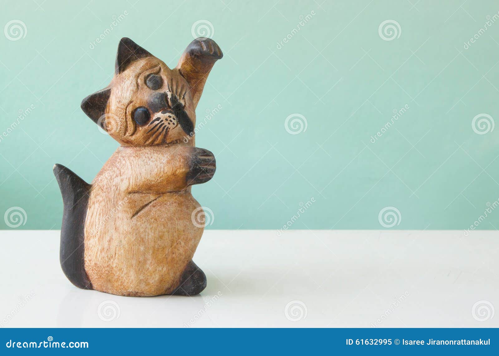 Carved Wooden Cats on a Table with Green Backgrounds Stock Image