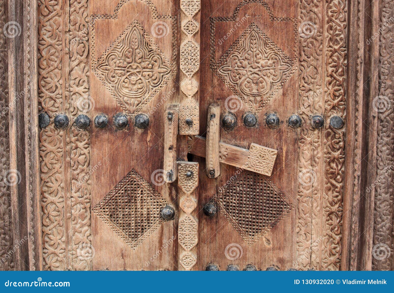 carved wooden door and ornate doorway in bahrain