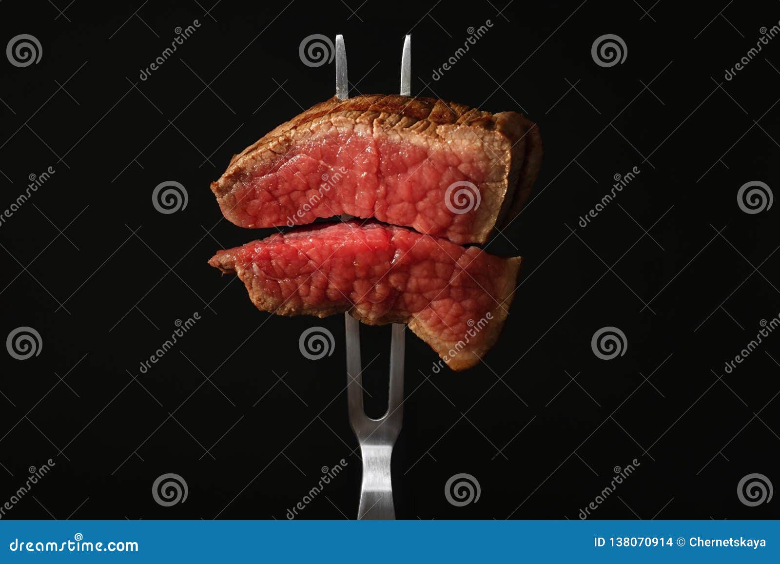 Carving Fork with Pieces of Steak on Black. Tasty Meat Stock Photo ...