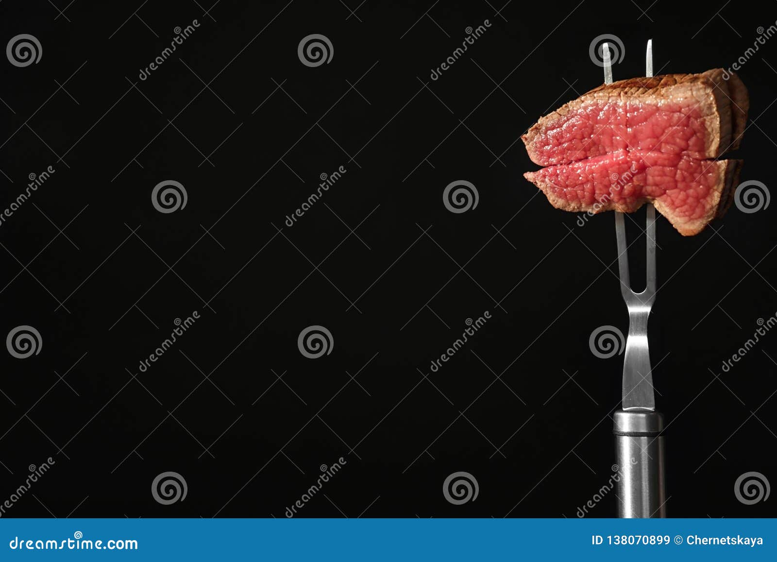 Carving Fork with Pieces of Steak and Space for Text on Black ...