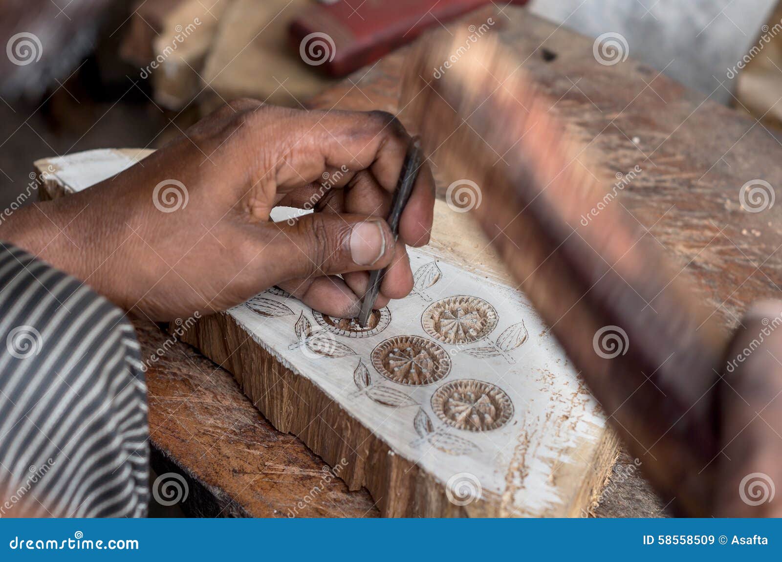 carving a wooden printing block for textile block printing