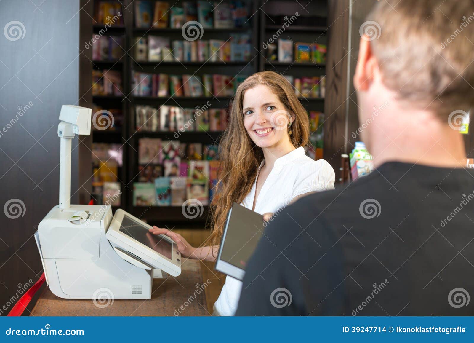 Cashier in Bookstore Serving a Customer or Client Stock Photo Image