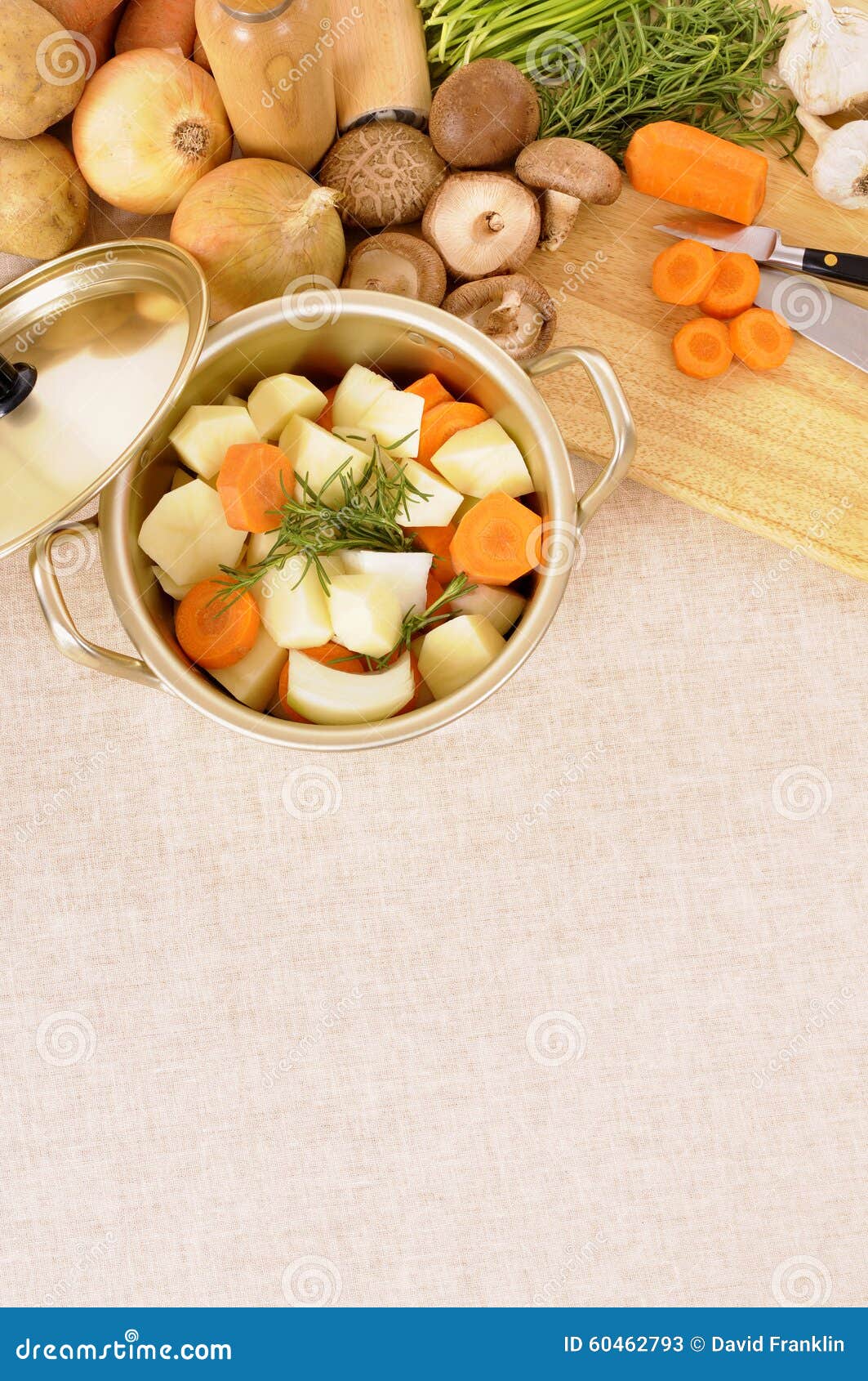 casserole dish or stockpot with organic vegetables and kitchen chopping board, copy space, vertical