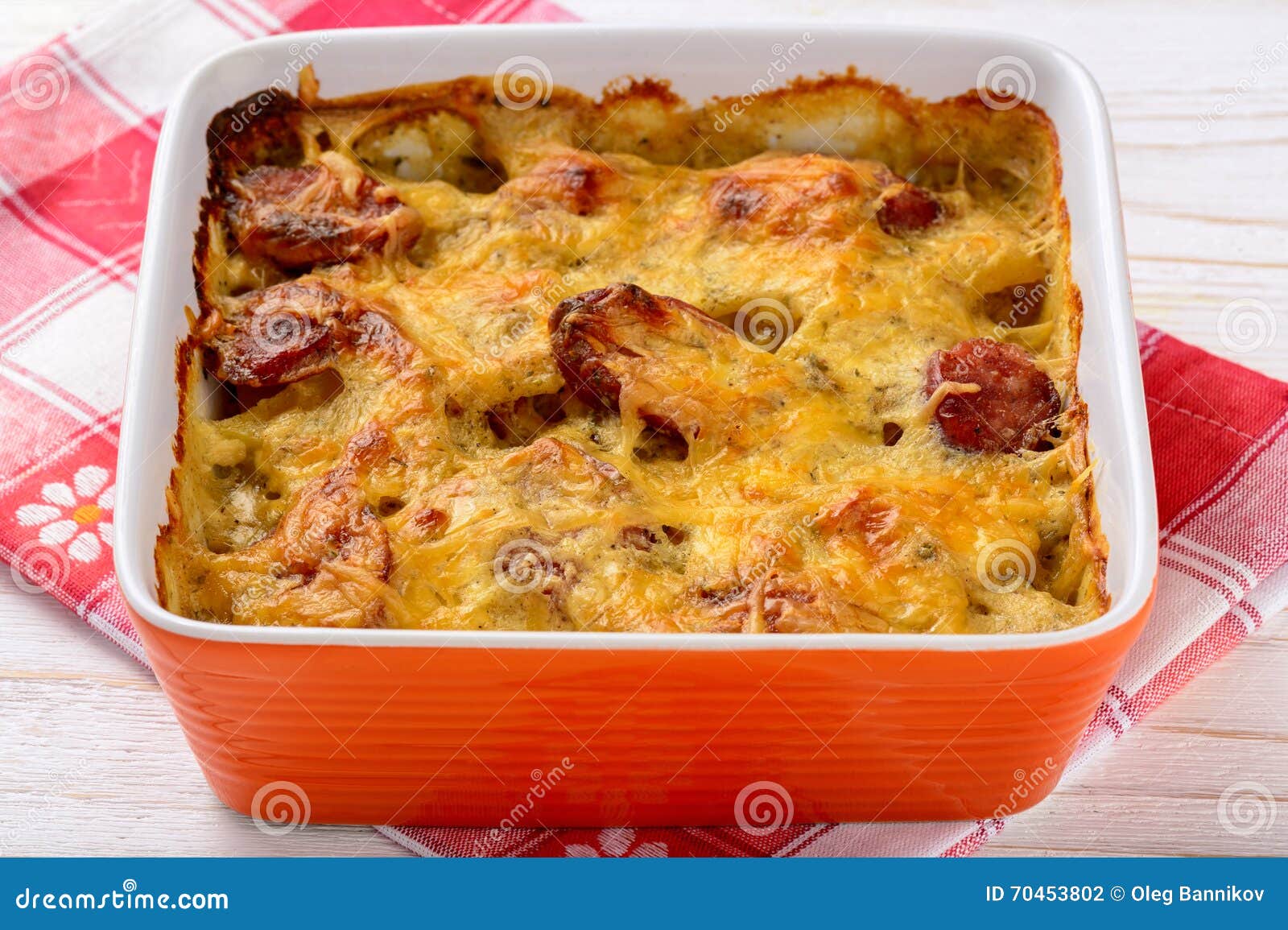 Casserole with Potatoes, Sausages, Tomatoes and Cheese. Stock Photo