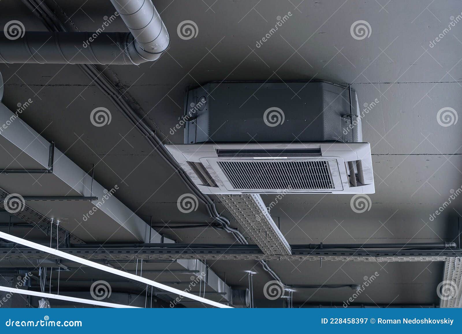 Cassette Split System on Gray Ceiling with Ventilation Ducts Stock
