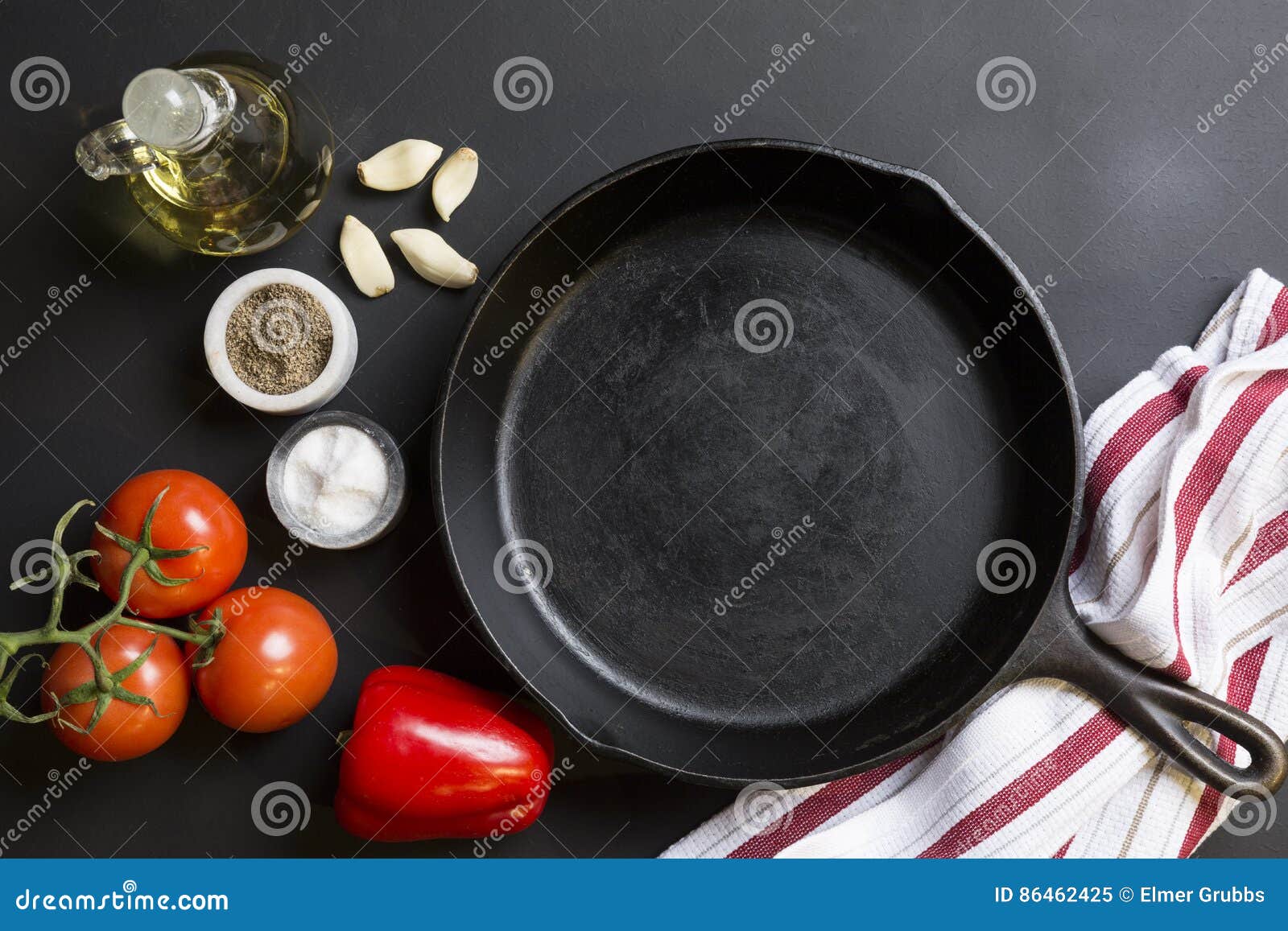 Cast Iron Skillet with Copy Area on Black Background with Ingredients