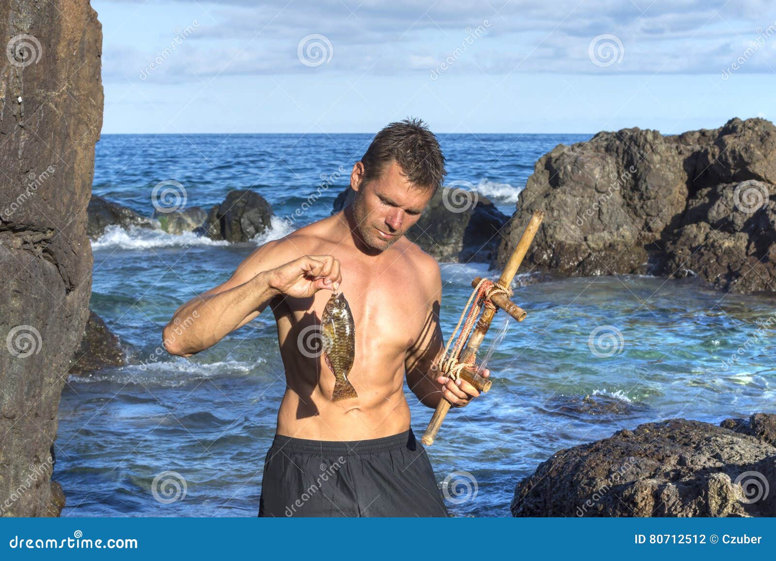 https://thumbs.dreamstime.com/z/castaway-fishing-primitive-tool-lean-shirtless-adventure-man-holds-fresh-caught-parrotfish-rod-rocky-caribbean-shore-80712512.jpg