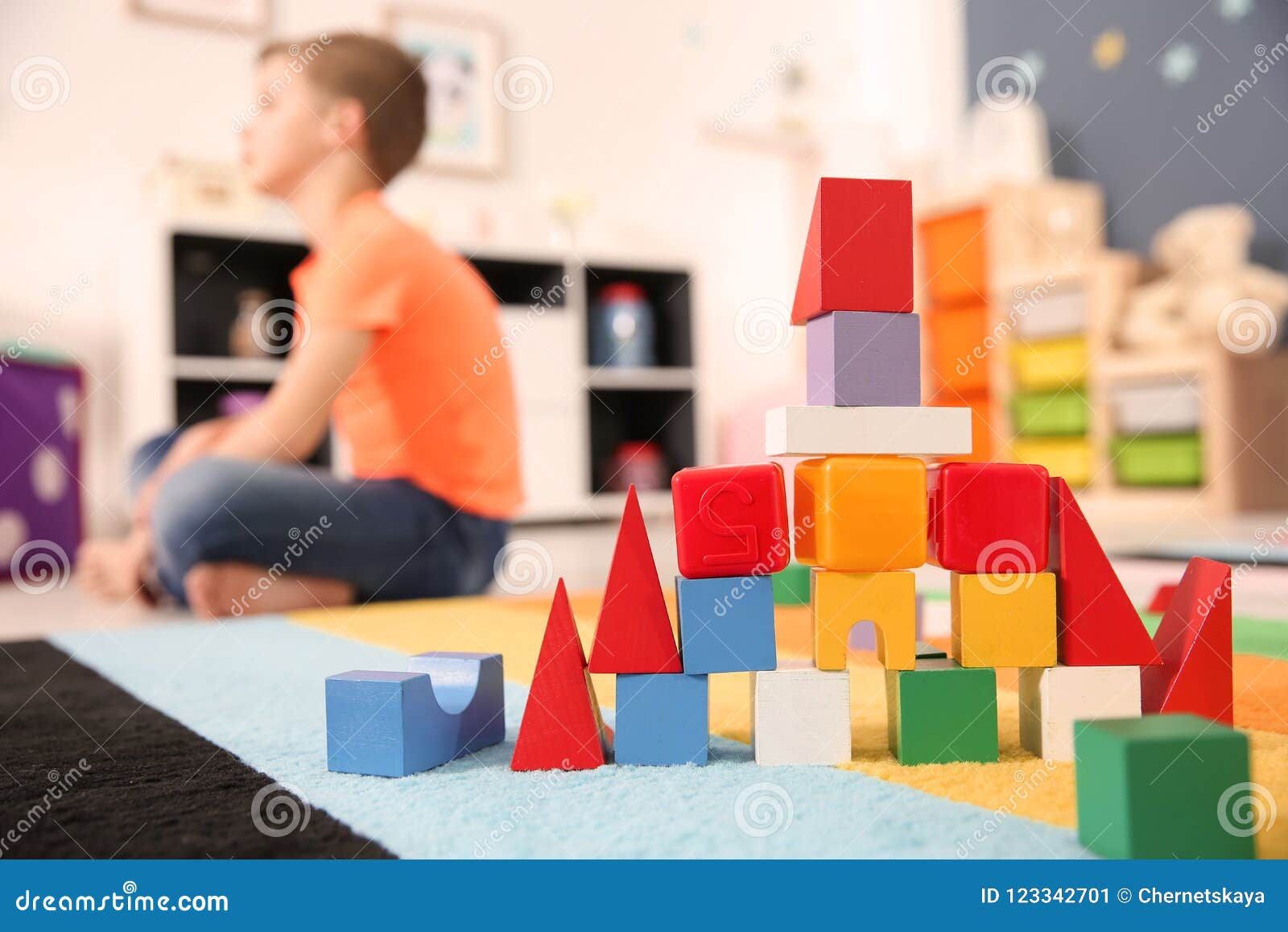 castle made from cubes and little boy with autistic disorder